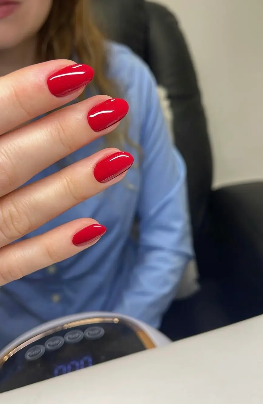 Classic glossy red rounded manicure