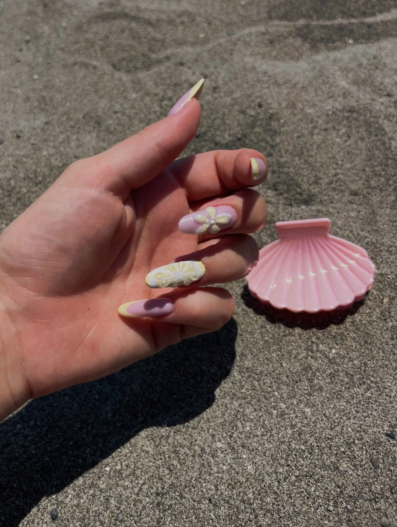 Colourful almond nail art photographed by the sea in Malta