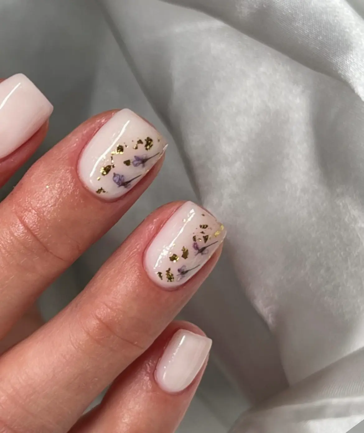 Ivory square nails with delicate gold nail art details