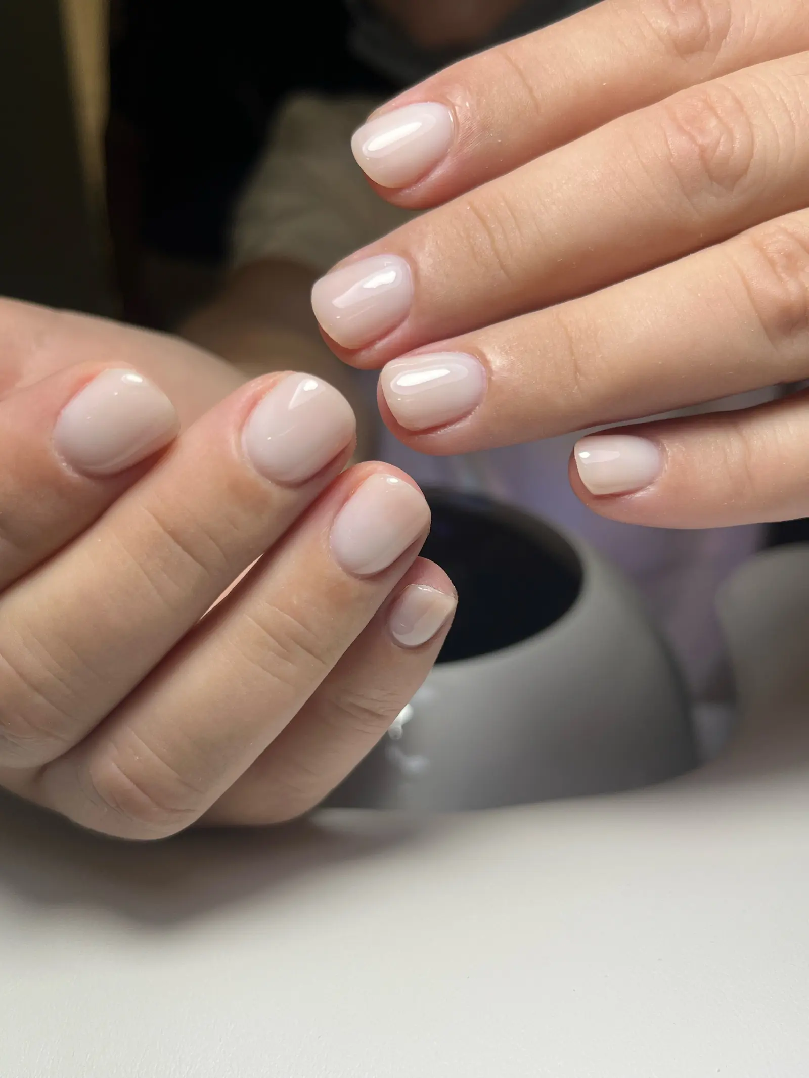 Short glossy nude manicure with a clean natural finish
